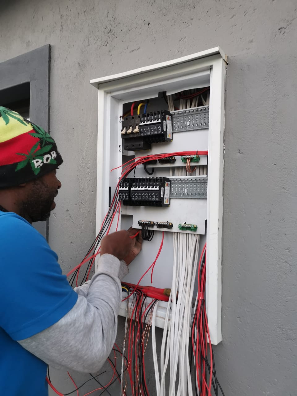 worker wiring electrical distribution box