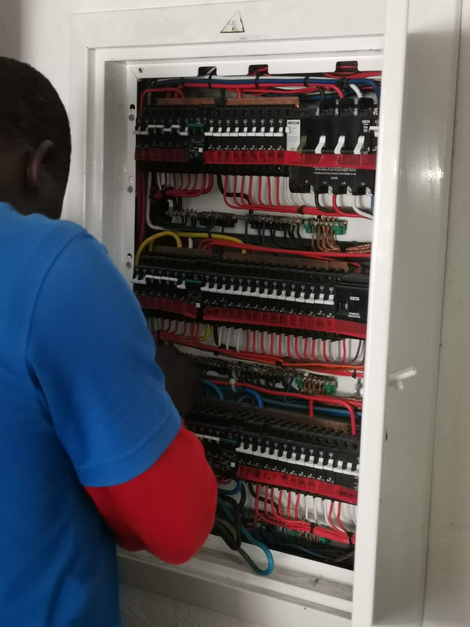 worker wiring a distribution box