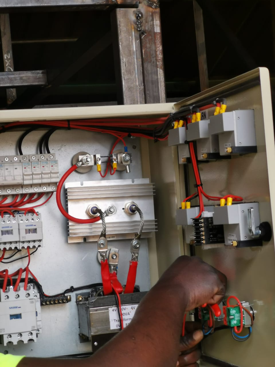 worker servicing boiler control unit