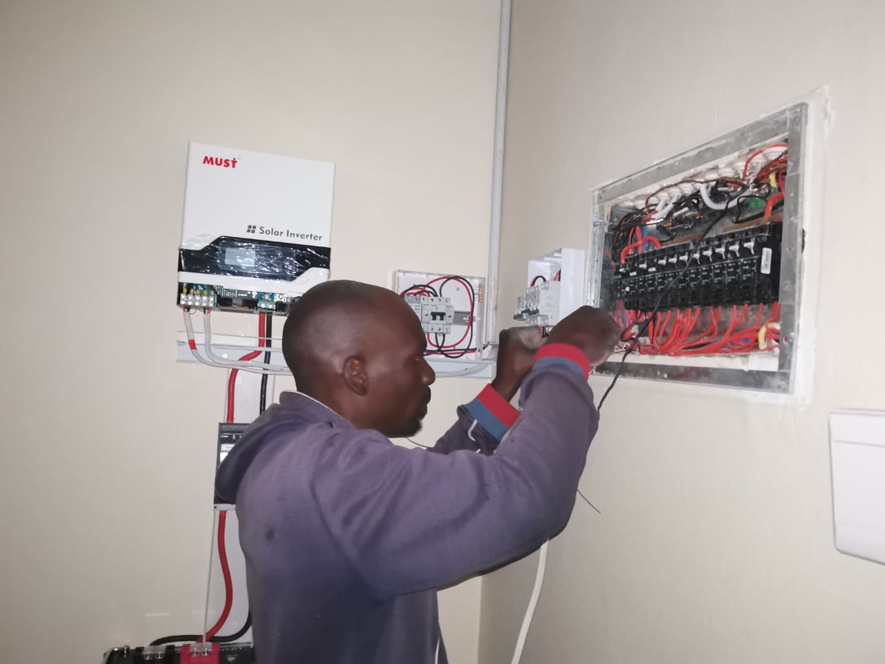 worker servicing distribution board 