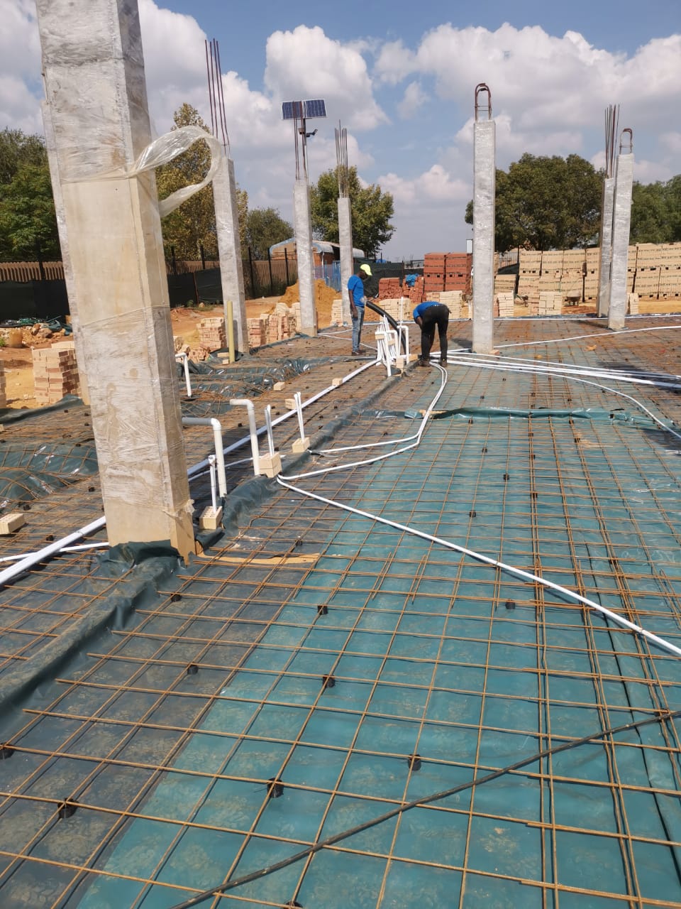 worker installing conduit tubing
